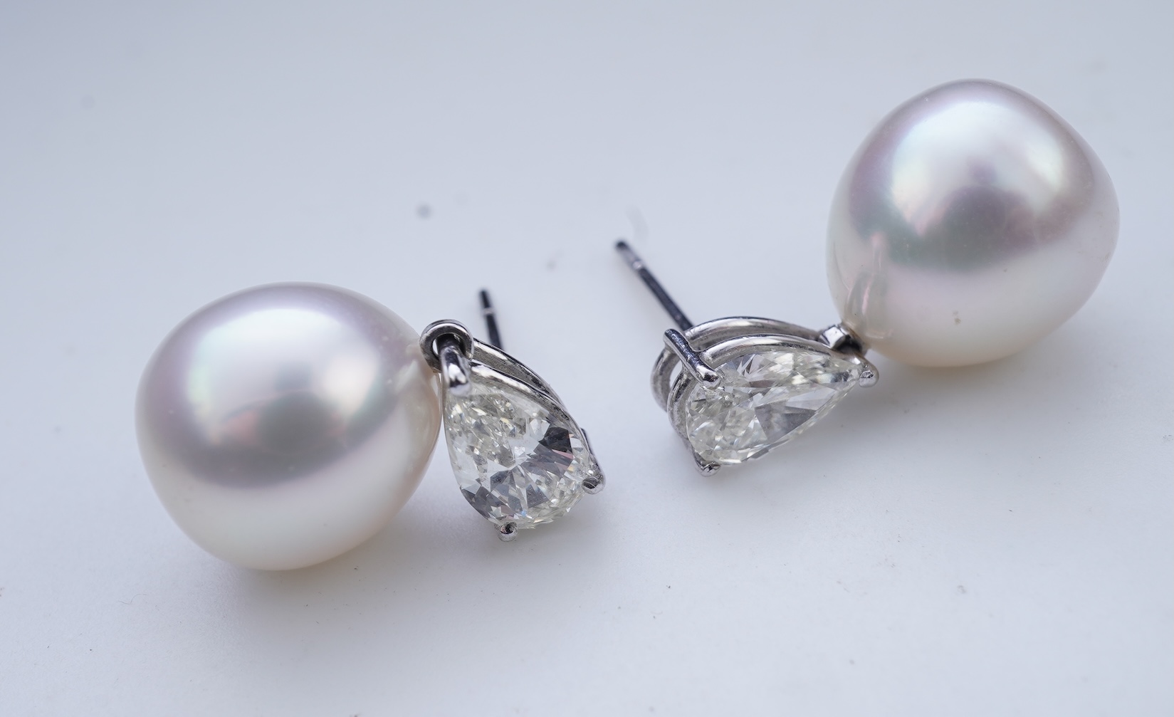 A pair of cultured pearl and diamond earrings